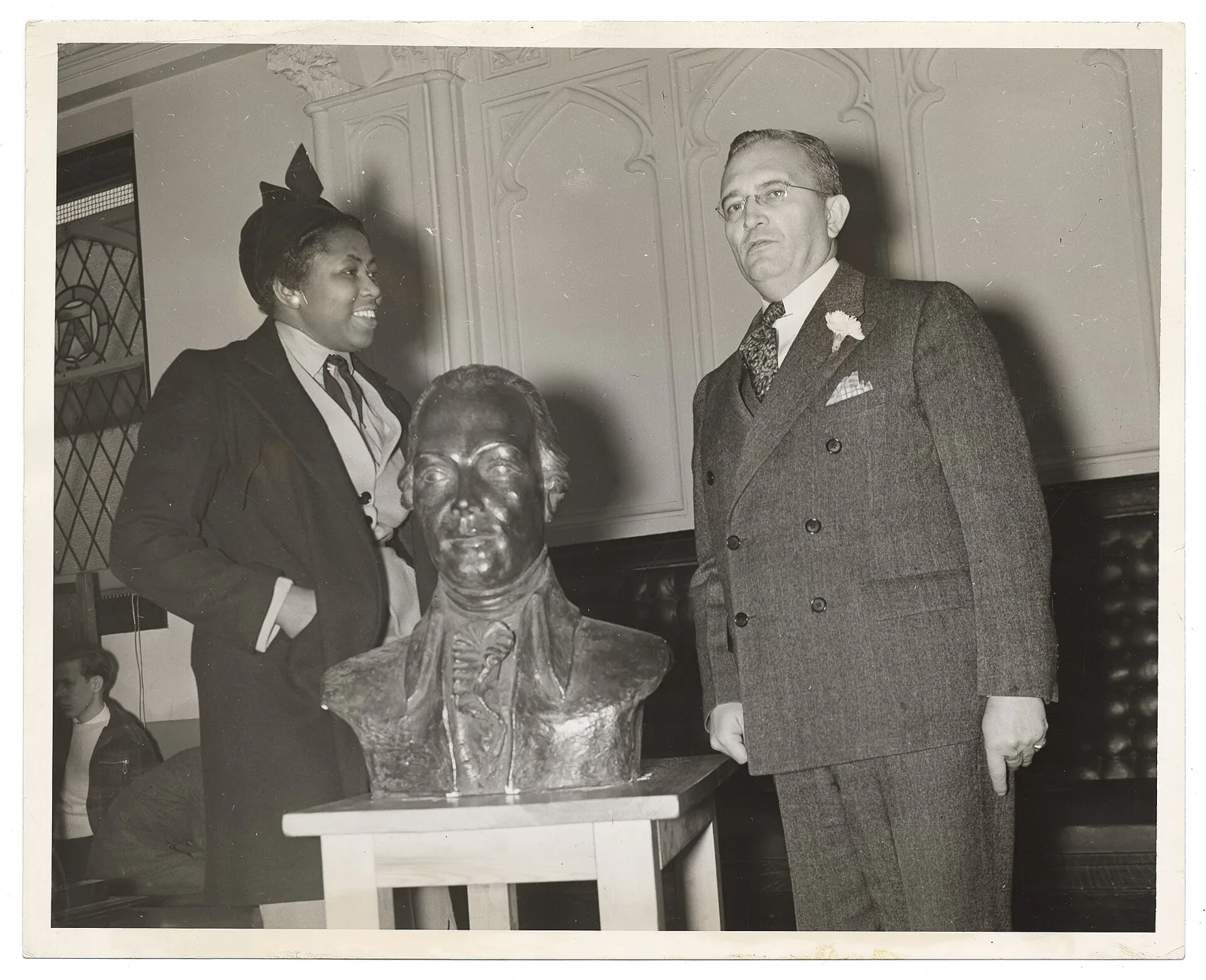 Mooresville-born sculptor Selma Burke beside her portrait bust of Samuel Huntington at a school ceremony in Jamaica, New York.