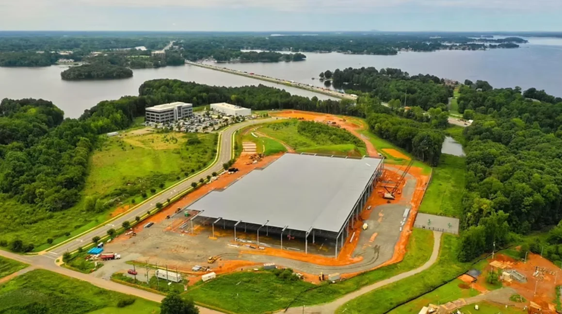 Corvid Technologies' Mooresville campus during construction of an earlier manufacturing building, with Lake Norman behind it