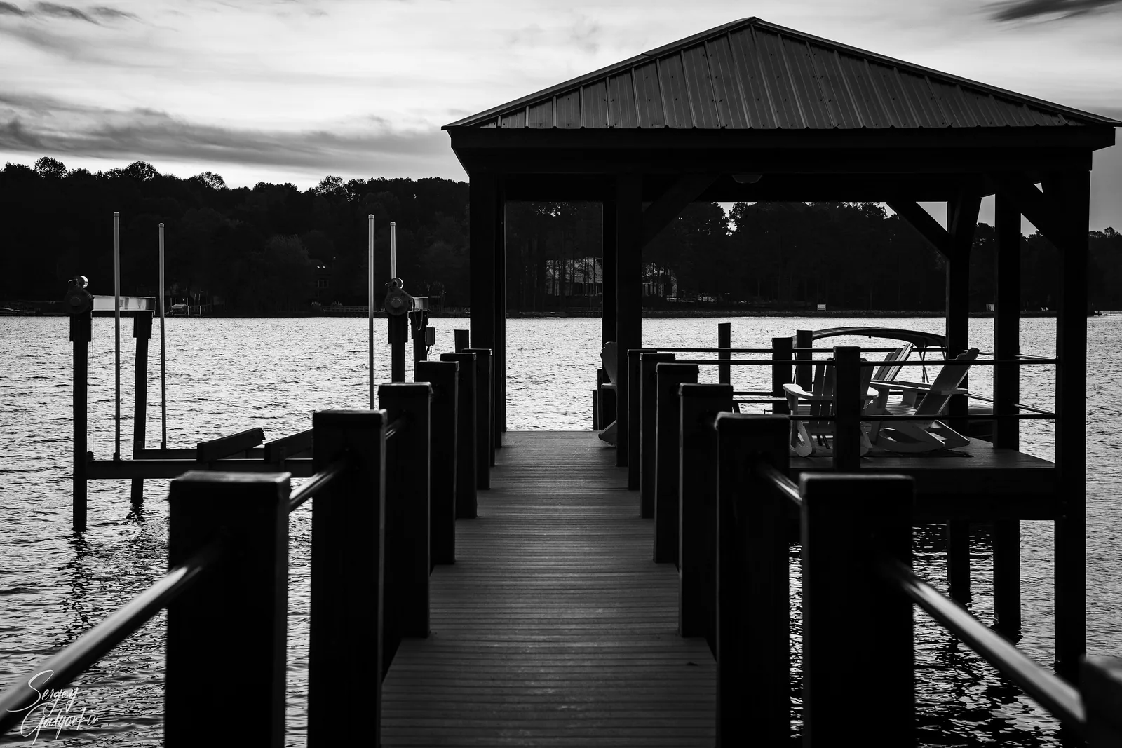 A covered boat dock on Lake Norman at sunset