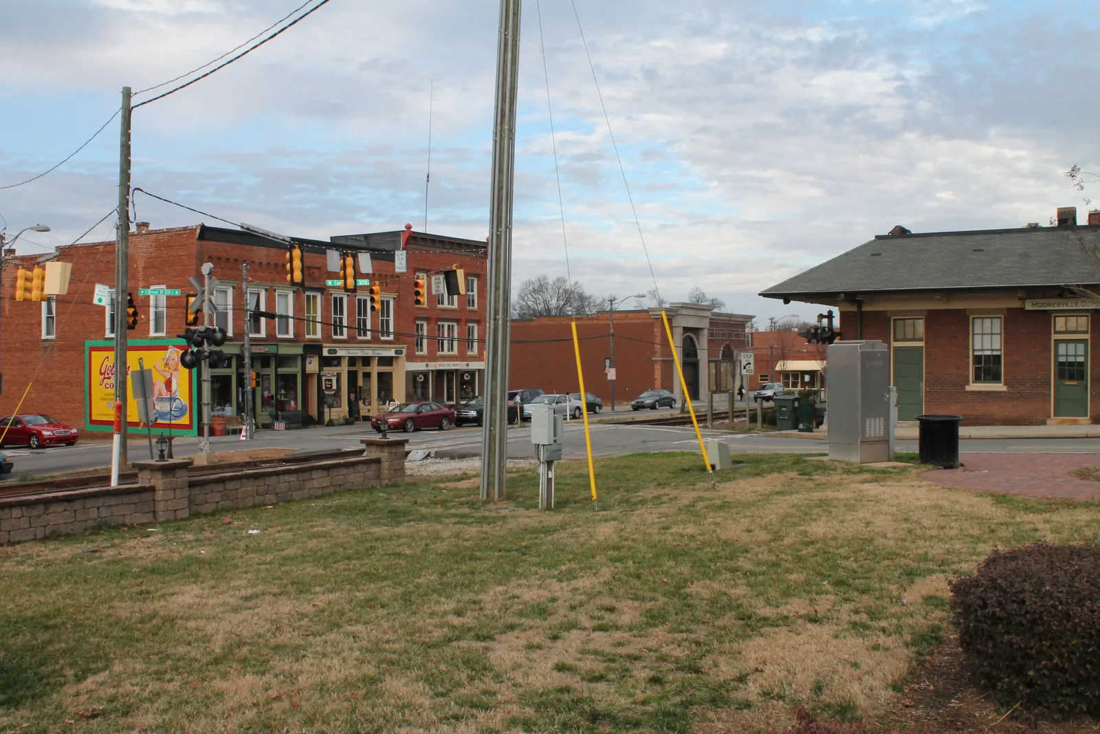 Brick storefronts on Broad Street and the brick railroad depot across the tracks in the Mooresville Historic District