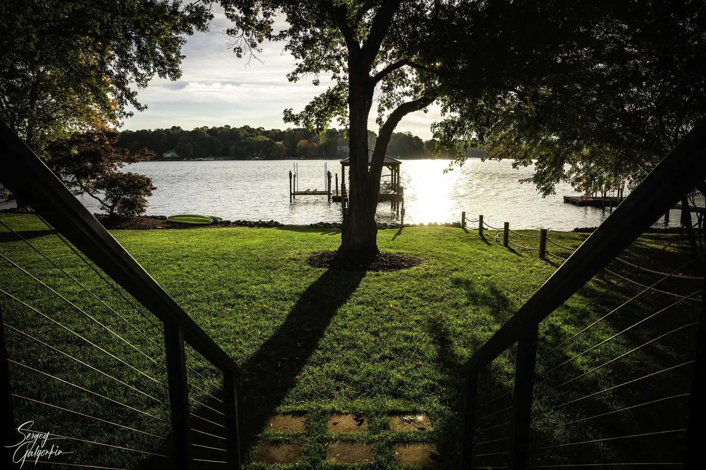 A lakeside lawn and boat dock on Lake Norman in the afternoon sun
