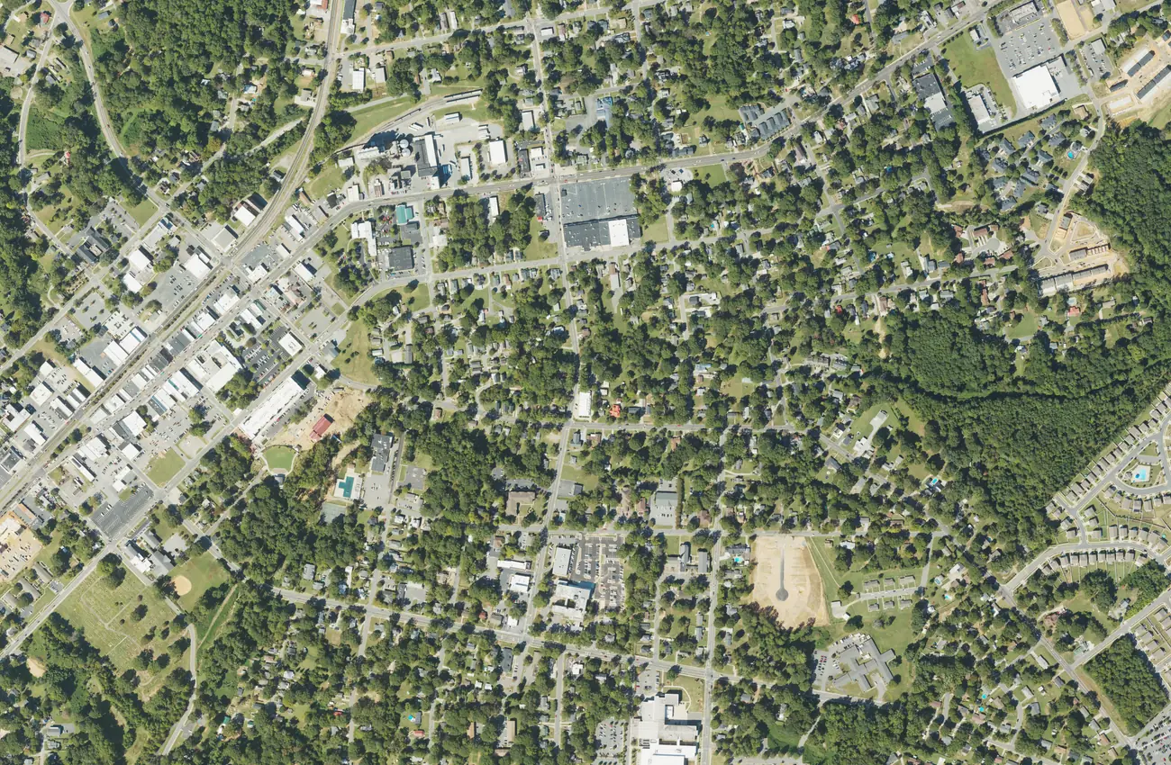 Aerial view of downtown Mooresville, with the Main Street blocks and the railroad at left and older residential streets to the east