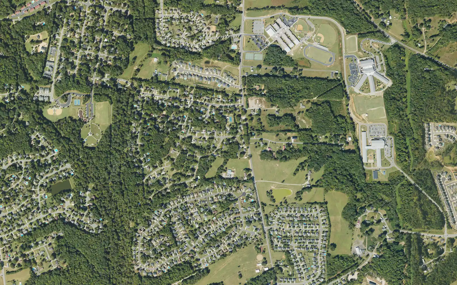 Aerial view of south Mooresville, with the Mooresville Middle, Mooresville Intermediate and Rocky River Elementary campuses at upper right, Bellingham Park's fields at left and subdivisions between