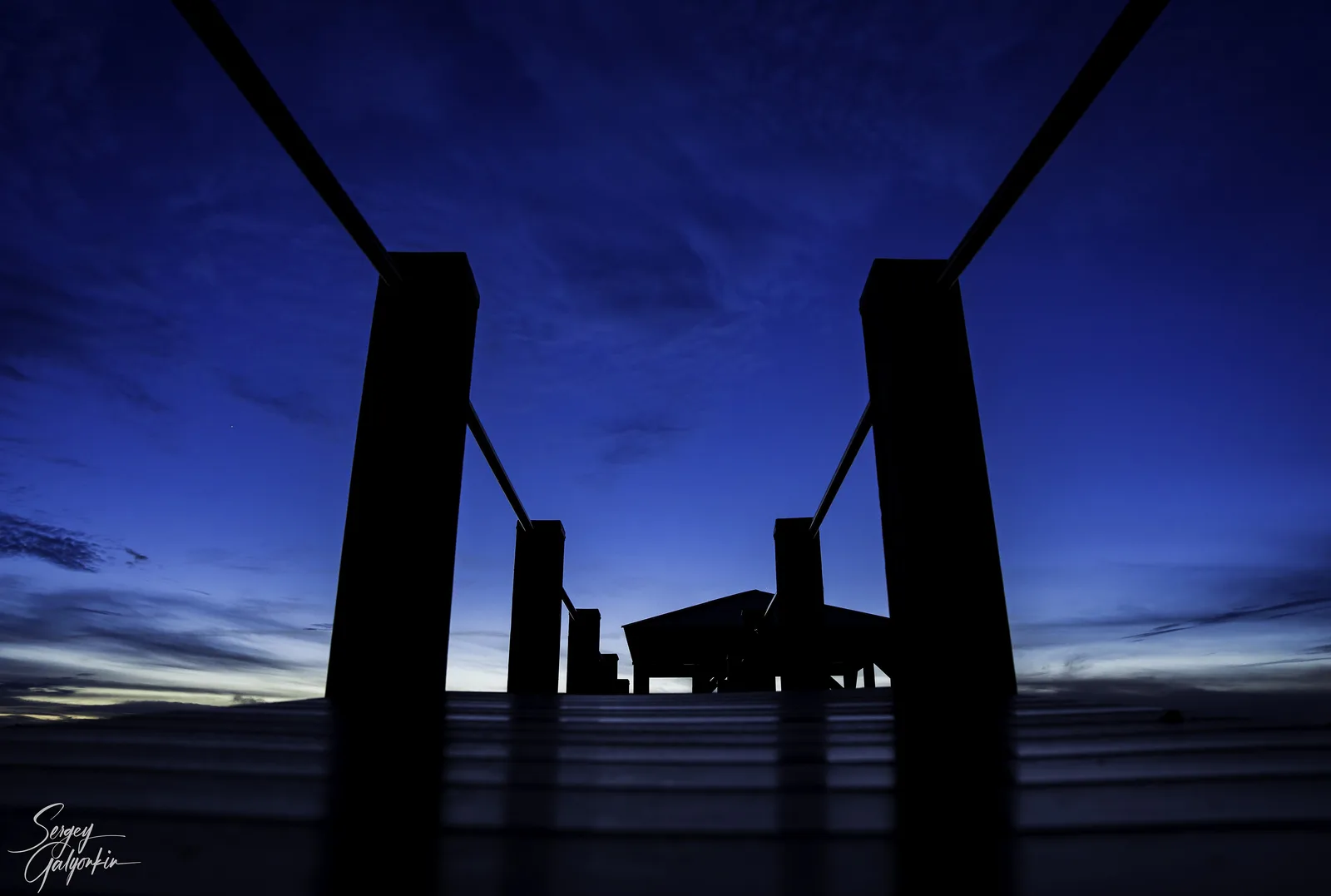 Dock posts silhouetted against the night sky over Lake Norman