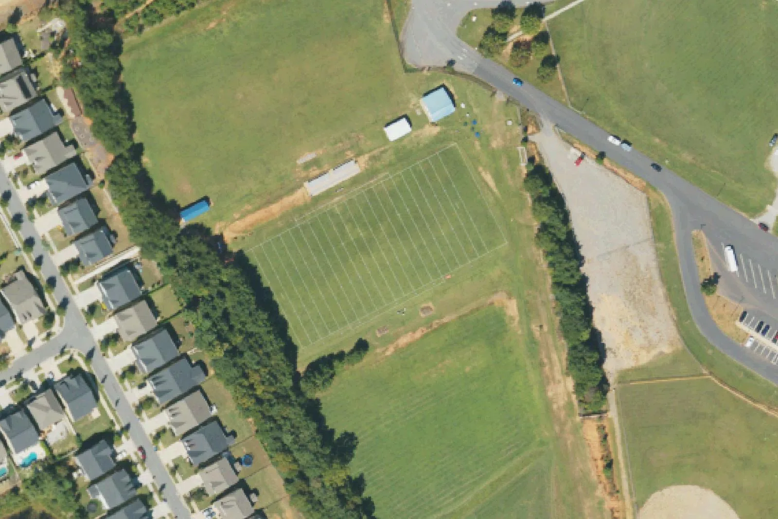 Athletic fields on the west side of the Lakeshore school campus off Lakeshore School Road in Mooresville, beside a neighborhood of new homes, seen from the air
