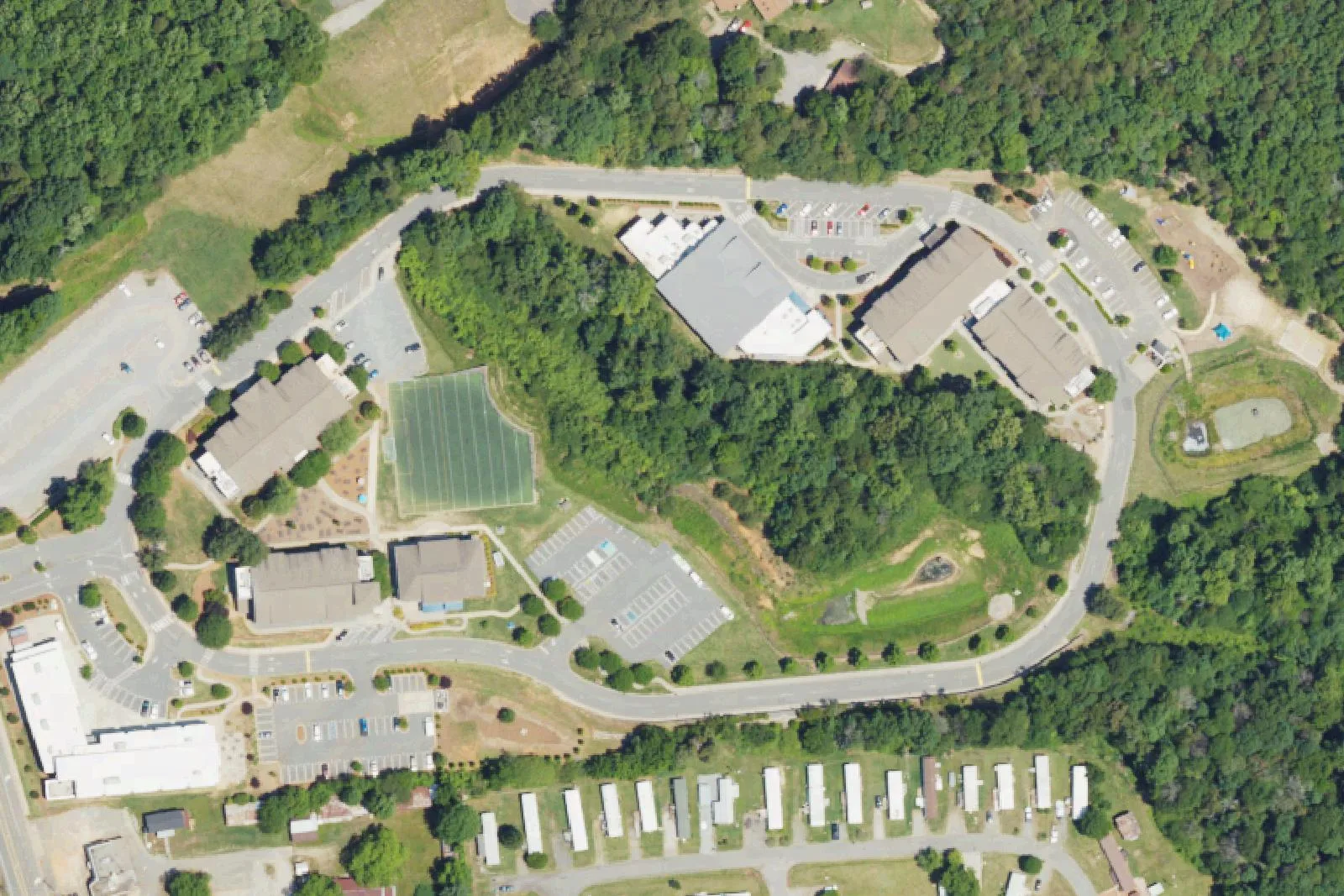 Pine Lake Preparatory's classroom buildings, turf field and campus loop road off Yellow Wood Circle in south Mooresville, seen from the air