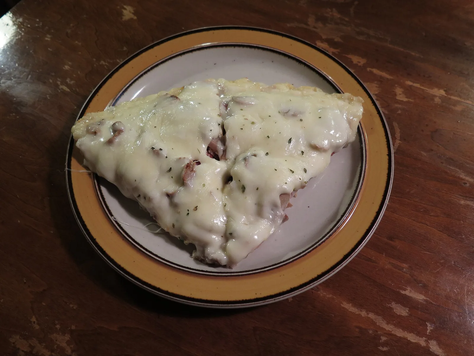 Two slices of pizza on a paper plate. The photo was not taken at a Mooresville restaurant.