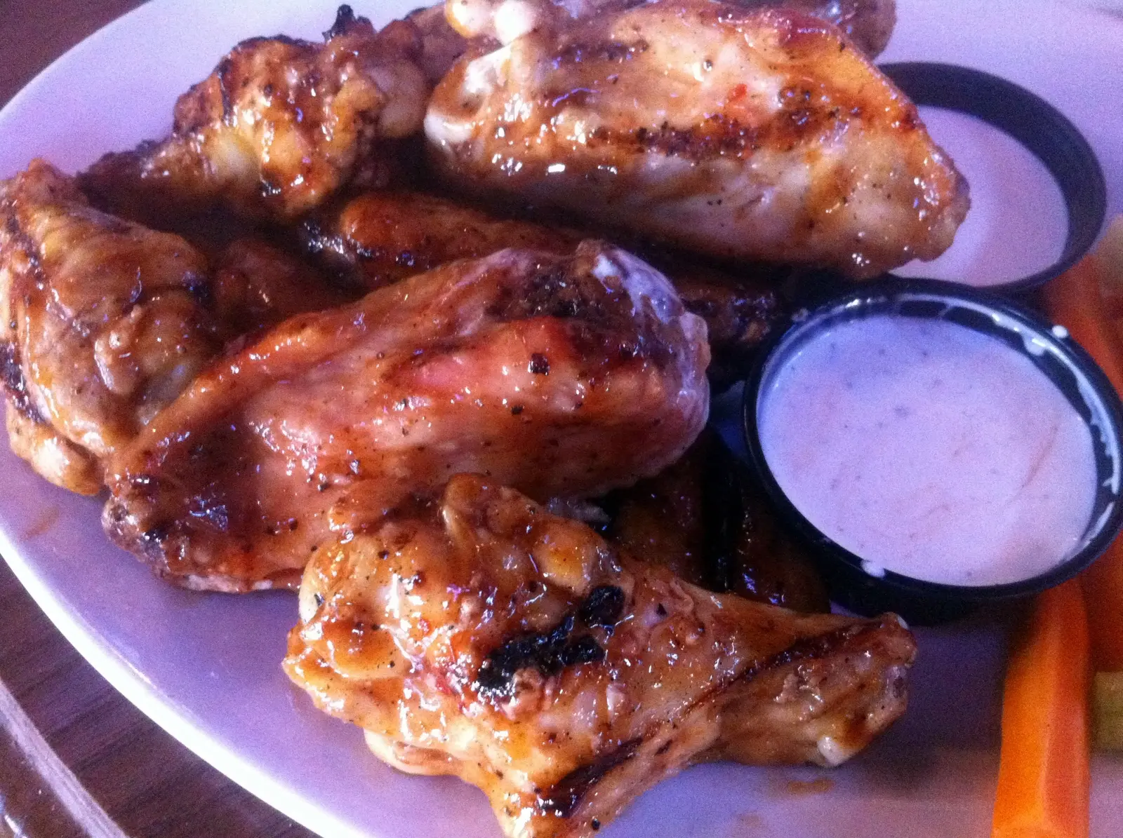 A plate of grilled chicken wings with dipping sauce at a Charlotte restaurant. The photo was not taken at a Mooresville restaurant.